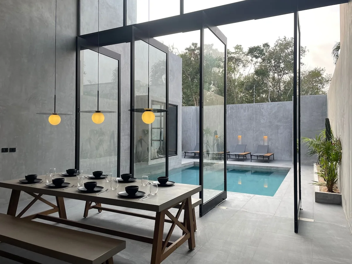 Casa Arroqueno luxury swimming pool area surrounded by tropical jungle vegetation and contemporary architecture