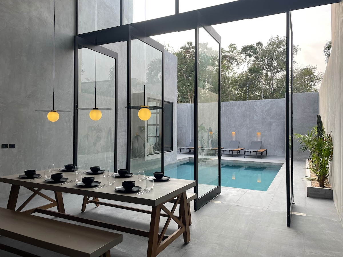 Casa Arroqueno luxury swimming pool area surrounded by tropical jungle vegetation and contemporary architecture