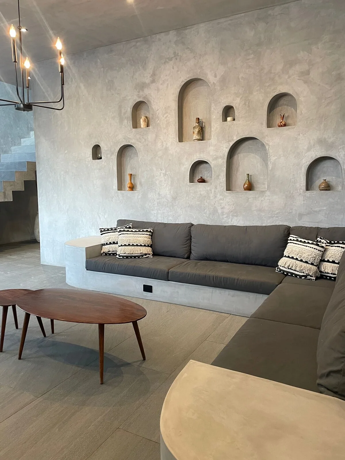 Casa Arroqueno contemporary living space featuring polished concrete finishes and natural light