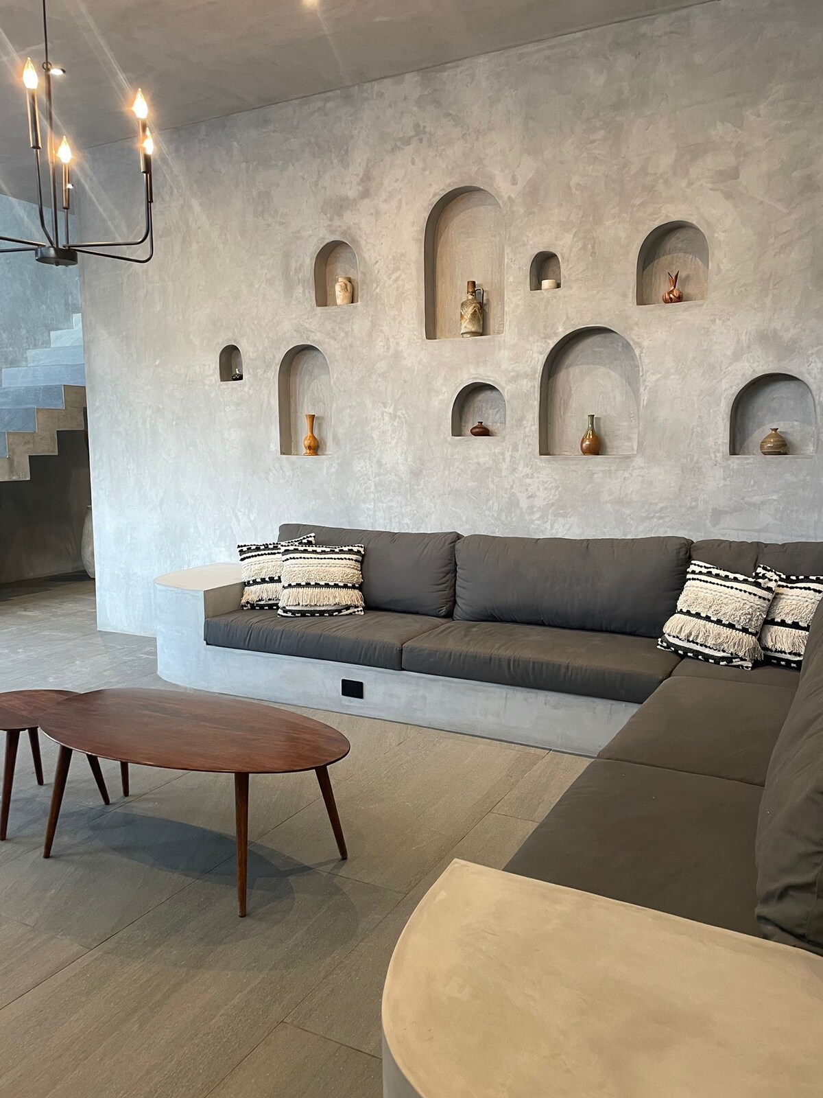 Casa Arroqueno contemporary living space featuring polished concrete finishes and natural light