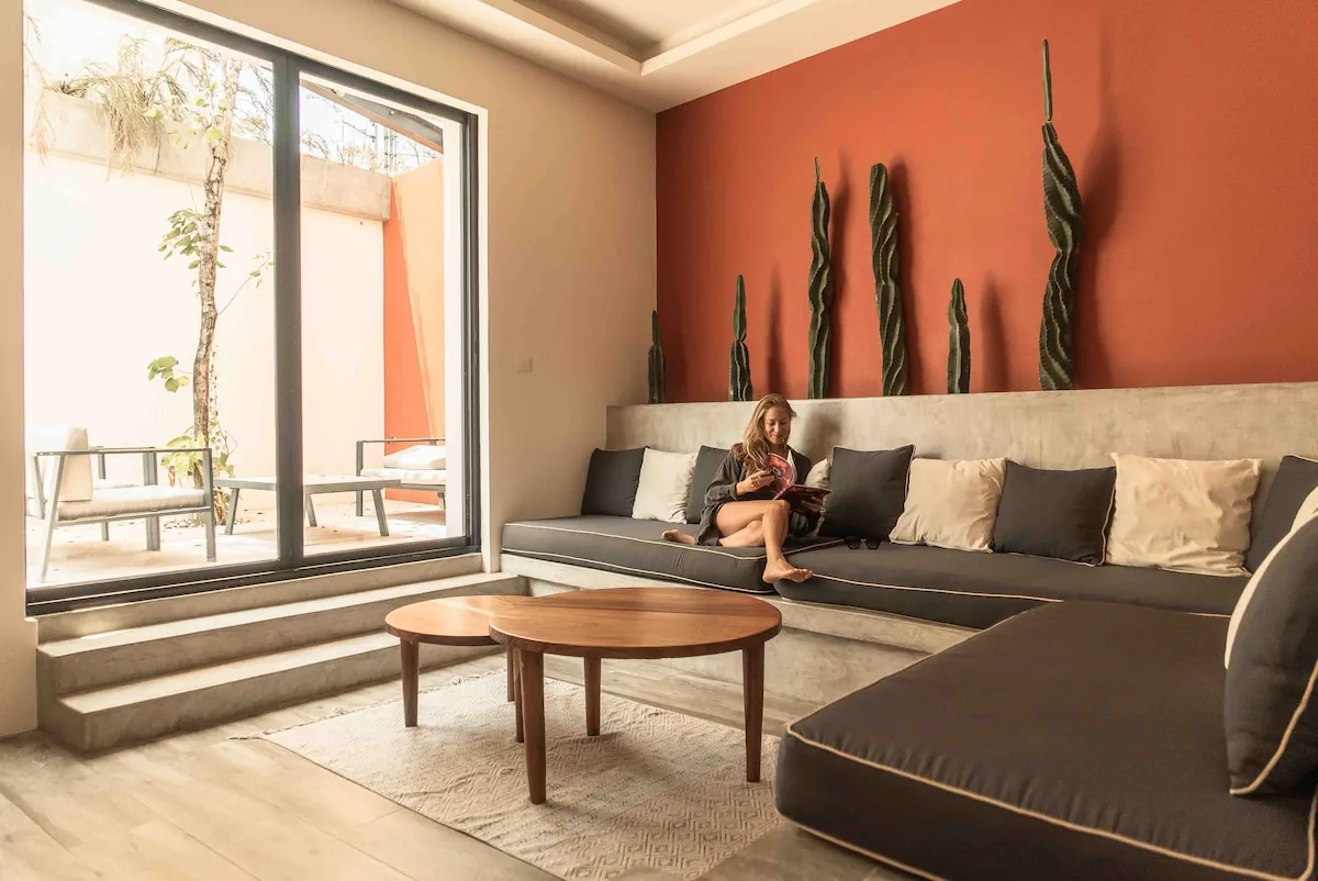 Casa Sueño spacious pool area with lounge chairs and tropical garden designed by Clémence